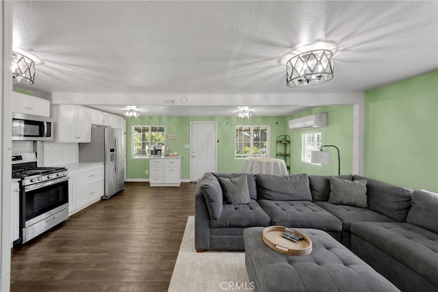 1003 Stevenson St, Colton, CA 92324 - living area with an AC wall unit, healthy amount of natural light, a textured ceiling, and dark wood-style floors