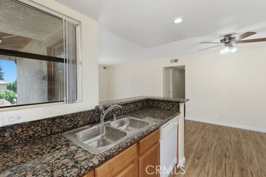 1313 Massachusettes Ave Unit 203, Riverside, CA 92507 - kitchen with dishwasher, light wood finished floors, a ceiling fan, brown cabinets, and dark stone counters