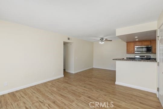 1313 Massachusettes Ave Unit 203, Riverside, CA 92507 - unfurnished living room featuring a ceiling fan and light wood finished floors