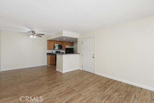 1313 Massachusettes Ave Unit 203, Riverside, CA 92507 - unfurnished living room with light wood-style floors and ceiling fan