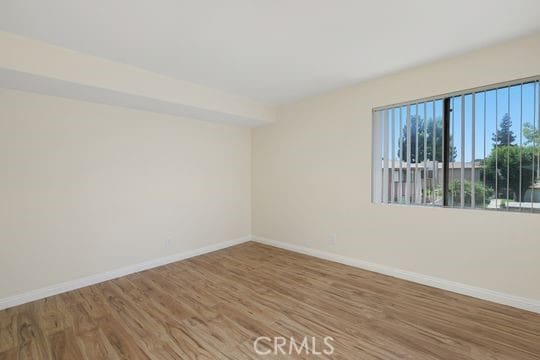 1313 Massachusettes Ave Unit 203, Riverside, CA 92507 - empty room with wood finished floors and baseboards
