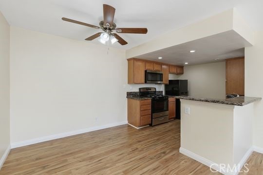 1313 Massachusettes Ave Unit 203, Riverside, CA 92507 - kitchen with stainless steel appliances, light wood finished floors, brown cabinets, ceiling fan, and recessed lighting