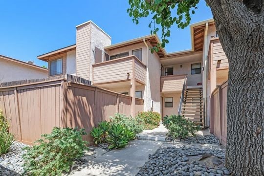 1313 Massachusettes Ave Unit 203, Riverside, CA 92507 - rear view of property featuring stairway, stucco siding, and a chimney