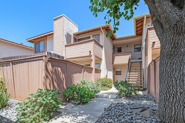 1313 Massachusettes Ave Unit 203, Riverside, CA 92507 - back of house with stairway and stucco siding
