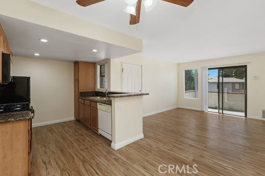 1313 Massachusettes Ave Unit 203, Riverside, CA 92507 - kitchen featuring white dishwasher, wood finished floors, ceiling fan, a peninsula, and open floor plan