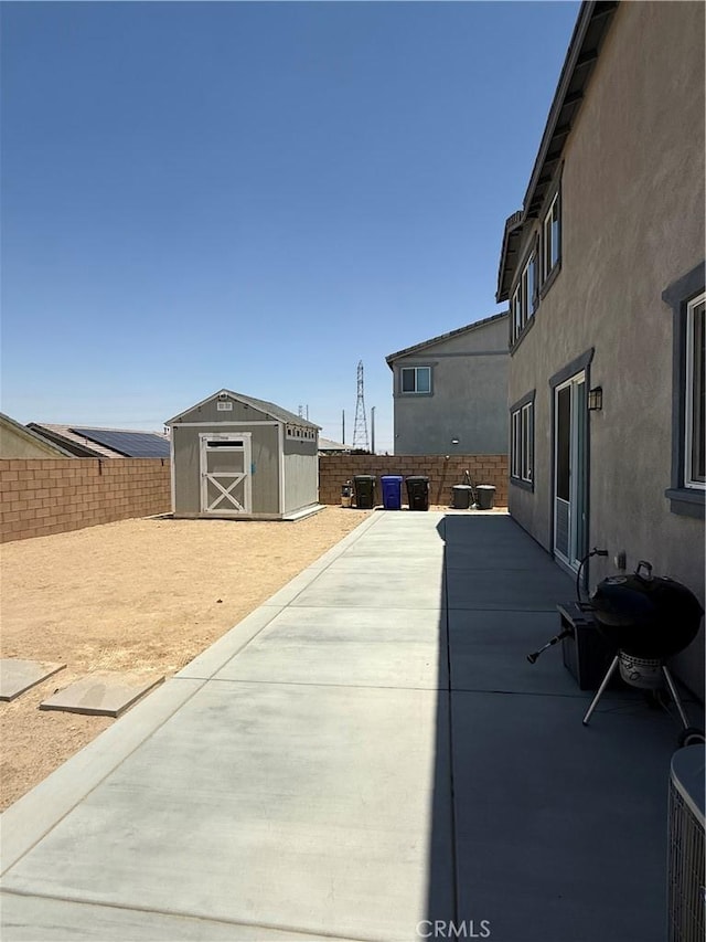 12708 Ojo Caliente St, Victorville, CA 92392 - fenced backyard featuring a storage unit and a patio area