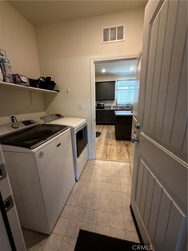 12708 Ojo Caliente St, Victorville, CA 92392 - laundry area featuring separate washer and dryer and light flooring