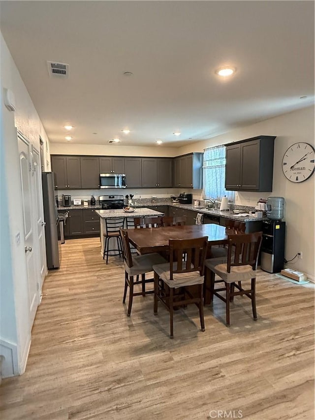 12708 Ojo Caliente St, Victorville, CA 92392 - kitchen with stainless steel appliances, light wood-type flooring, and recessed lighting