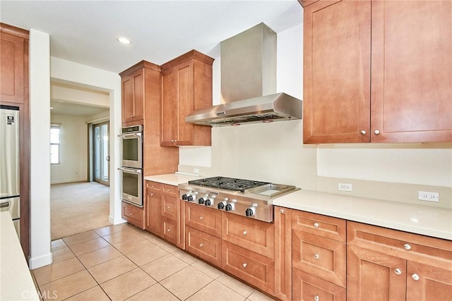 245 Snapdragon Ln, Glendora, CA 91741 - kitchen with wall chimney range hood, appliances with stainless steel finishes, light tile patterned floors, light countertops, and light colored carpet