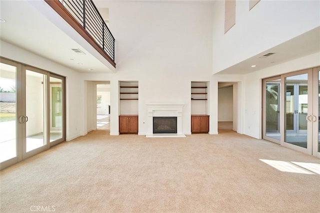 245 Snapdragon Ln, Glendora, CA 91741 - unfurnished living room featuring french doors, light colored carpet, healthy amount of natural light, and a high ceiling