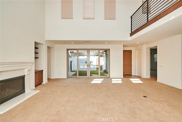 245 Snapdragon Ln, Glendora, CA 91741 - unfurnished living room with light carpet, a high ceiling, a glass covered fireplace, and recessed lighting