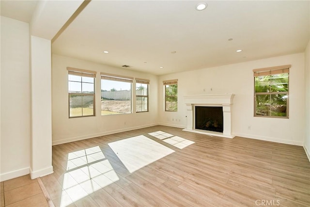 245 Snapdragon Ln, Glendora, CA 91741 - unfurnished living room with light wood-type flooring, plenty of natural light, a fireplace with raised hearth, and recessed lighting