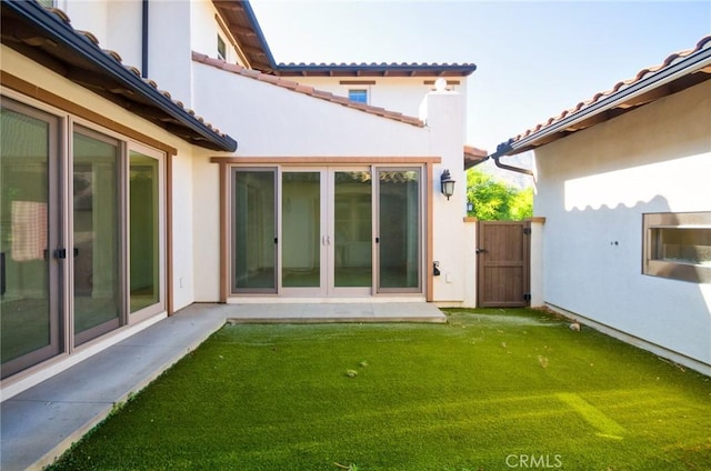 245 Snapdragon Ln, Glendora, CA 91741 - back of property featuring stucco siding, a tiled roof, a lawn, and a gate
