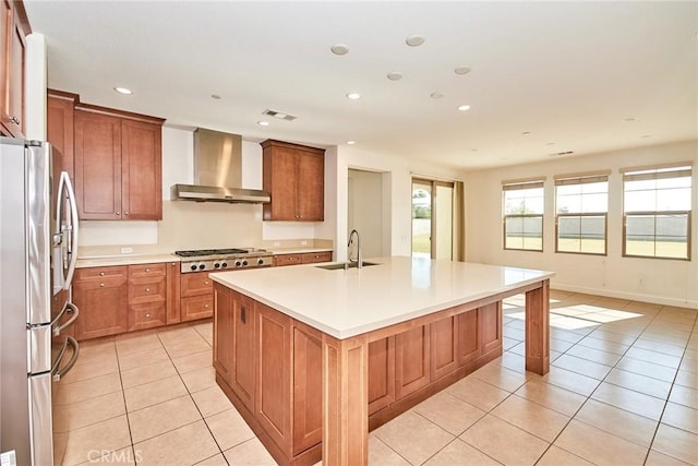 245 Snapdragon Ln, Glendora, CA 91741 - kitchen featuring stainless steel appliances, wall chimney exhaust hood, light tile patterned flooring, an island with sink, and recessed lighting