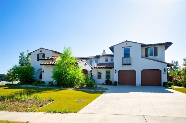 245 Snapdragon Ln, Glendora, CA 91741 - mediterranean / spanish home with a garage, a front lawn, concrete driveway, stucco siding, and a tile roof