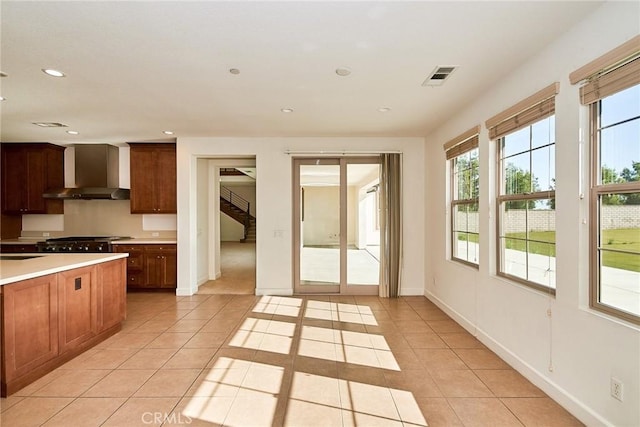 245 Snapdragon Ln, Glendora, CA 91741 - kitchen with wall chimney exhaust hood, recessed lighting, light tile patterned floors, light countertops, and brown cabinetry