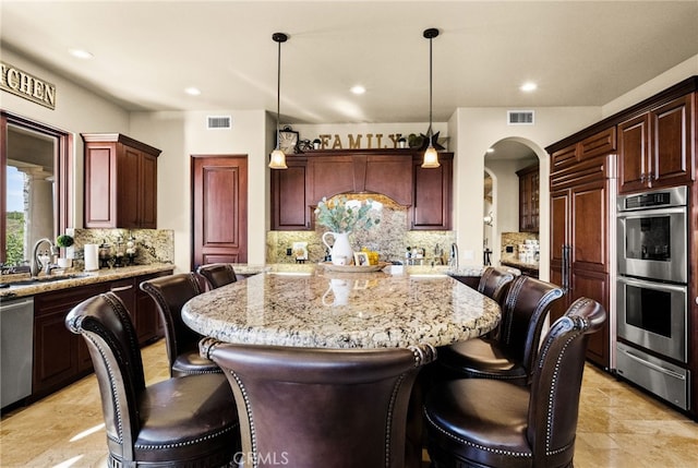 43650 La Cruz Dr, Temecula, CA 92590 - kitchen featuring stainless steel appliances, a warming drawer, a breakfast bar, a kitchen island, and recessed lighting