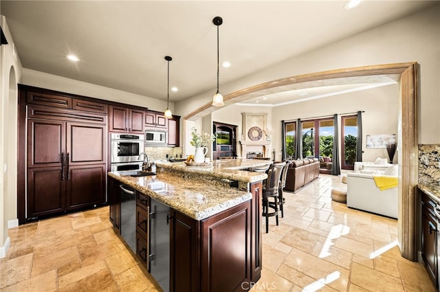 43650 La Cruz Dr, Temecula, CA 92590 - kitchen featuring stone tile flooring, stainless steel appliances, open floor plan, arched walkways, and recessed lighting
