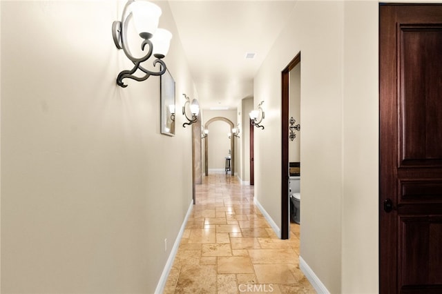 43650 La Cruz Dr, Temecula, CA 92590 - corridor featuring stone tile flooring and arched walkways
