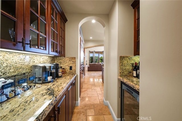 43650 La Cruz Dr, Temecula, CA 92590 - kitchen with stone tile floors, beverage cooler, arched walkways, backsplash, and recessed lighting