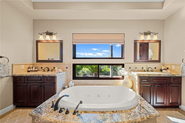 43650 La Cruz Dr, Temecula, CA 92590 - bathroom featuring two vanities, a whirlpool tub, and decorative backsplash