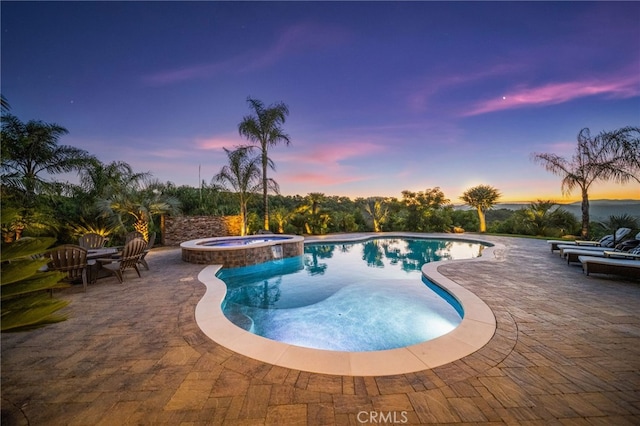 43650 La Cruz Dr, Temecula, CA 92590 - pool at dusk featuring a patio area and a pool with connected hot tub