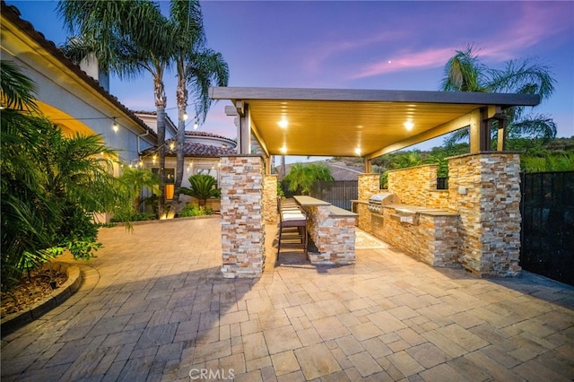 43650 La Cruz Dr, Temecula, CA 92590 - patio terrace at dusk featuring area for grilling, a patio, a fenced backyard, and a bar
