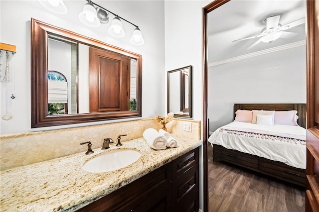 43650 La Cruz Dr, Temecula, CA 92590 - bathroom with vanity, ornamental molding, wood finished floors, tasteful backsplash, and a ceiling fan