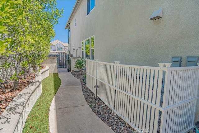25531 Durant Pl, Stevenson Ranch, CA 91381 - view of side of home with stucco siding and a gate