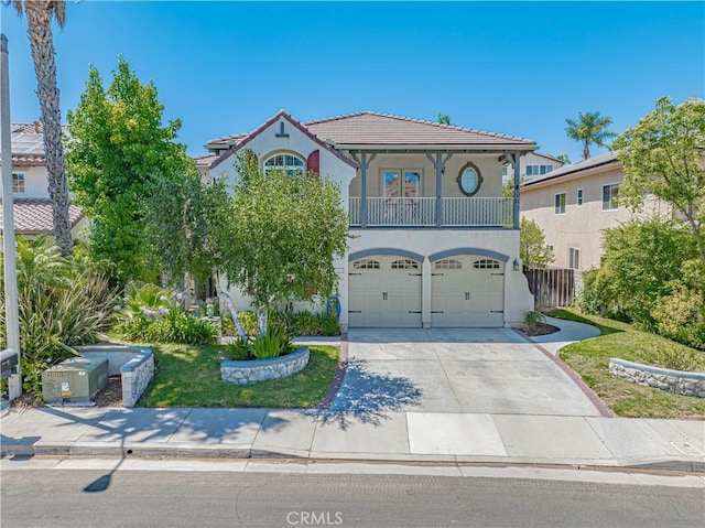 25531 Durant Pl, Stevenson Ranch, CA 91381 - mediterranean / spanish-style house featuring a balcony, stucco siding, driveway, an attached garage, and a tile roof