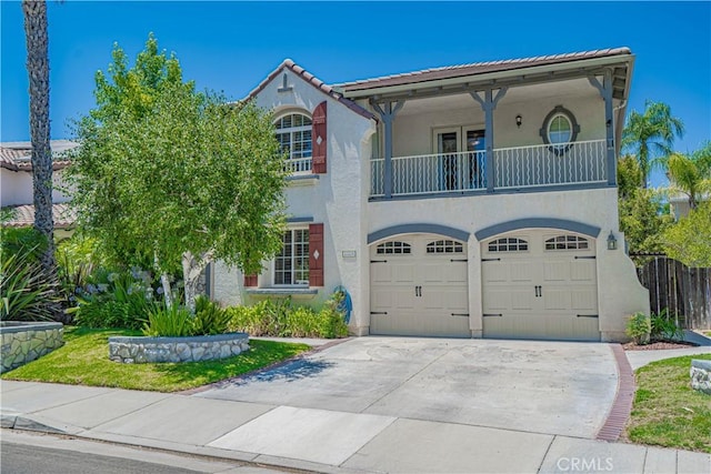 25531 Durant Pl, Stevenson Ranch, CA 91381 - mediterranean / spanish-style home featuring a balcony, stucco siding, concrete driveway, and a garage