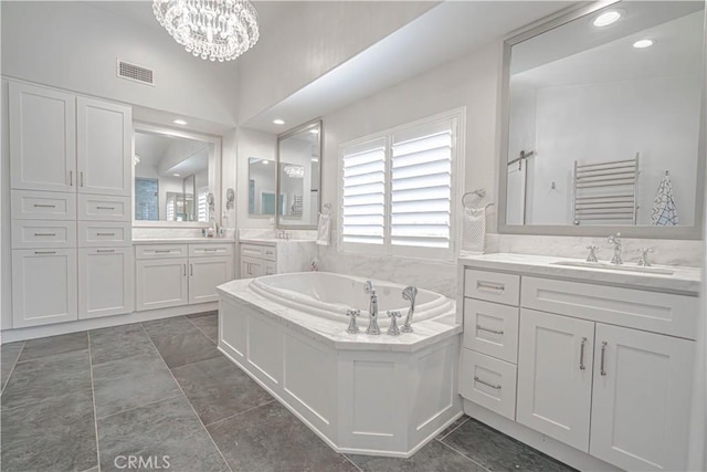 25531 Durant Pl, Stevenson Ranch, CA 91381 - bathroom featuring a garden tub, two vanities, a chandelier, and recessed lighting