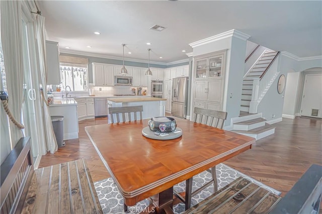 25531 Durant Pl, Stevenson Ranch, CA 91381 - dining space with stairs, ornamental molding, recessed lighting, and light wood-type flooring