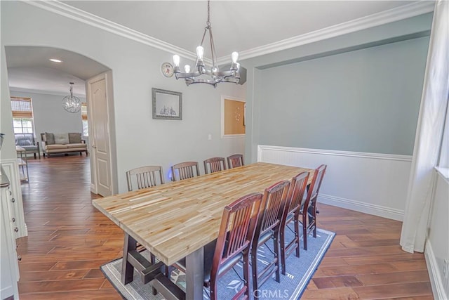 25531 Durant Pl, Stevenson Ranch, CA 91381 - dining space with a chandelier, crown molding, dark wood finished floors, and arched walkways