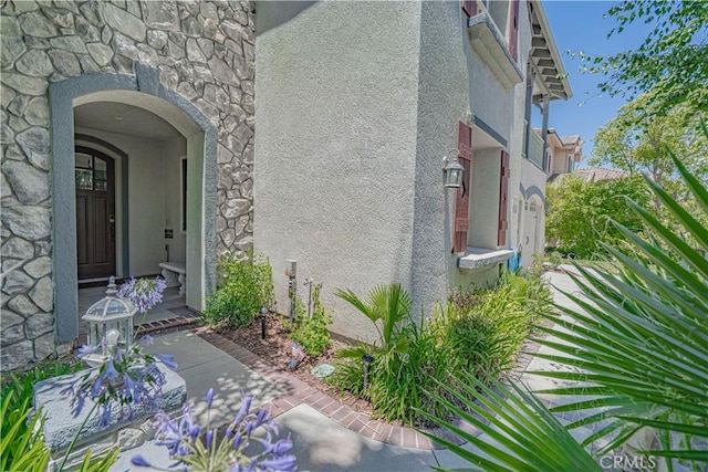 25531 Durant Pl, Stevenson Ranch, CA 91381 - view of exterior entry featuring stone siding and stucco siding