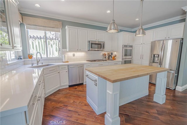 25531 Durant Pl, Stevenson Ranch, CA 91381 - kitchen with stainless steel appliances, butcher block countertops, a kitchen island, white cabinetry, and tasteful backsplash