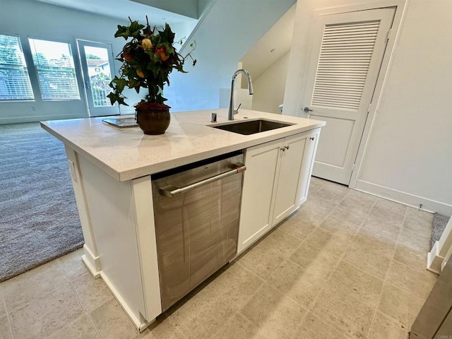 2170 Birch Rd Unit 111, Chula Vista, CA 91915 - kitchen featuring dishwasher, a kitchen island with sink, white cabinets, light colored carpet, and light stone counters
