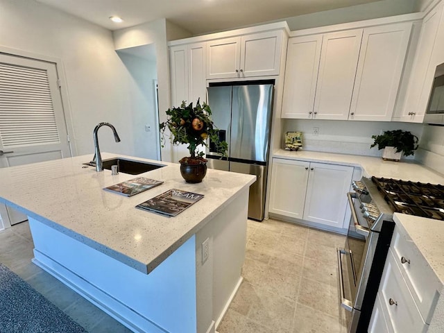 2170 Birch Rd Unit 111, Chula Vista, CA 91915 - kitchen with stainless steel appliances, white cabinets, recessed lighting, light stone countertops, and an island with sink