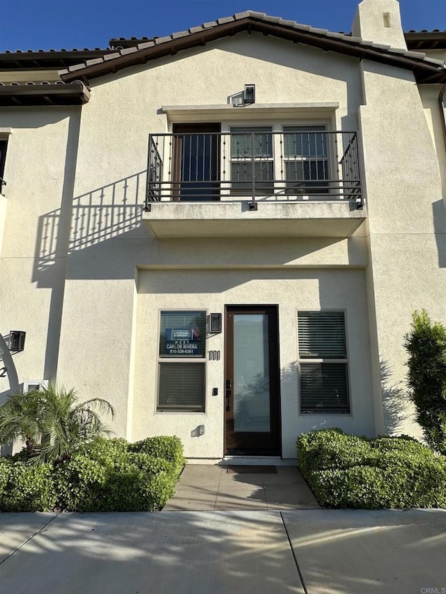 2170 Birch Rd Unit 111, Chula Vista, CA 91915 - entrance to property with a balcony, stucco siding, and a chimney