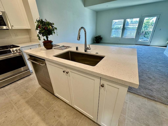 2170 Birch Rd Unit 111, Chula Vista, CA 91915 - kitchen featuring stainless steel appliances, white cabinetry, light stone counters, and light colored carpet