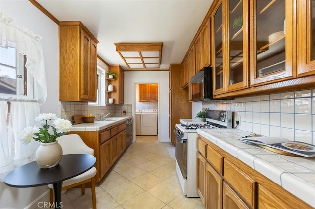 1137 Lafayette St, San Gabriel, CA 91776 - kitchen featuring white gas range, tile countertops, washing machine and clothes dryer, black microwave, and brown cabinetry