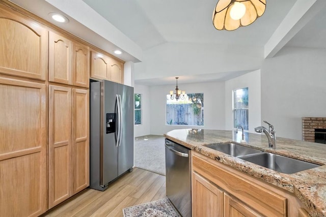 5261 Hubbert St, Oceanside, CA 92056 - kitchen with stainless steel appliances, light brown cabinetry, a chandelier, light wood-style floors, and light stone countertops