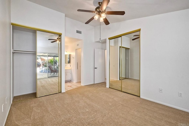 5261 Hubbert St, Oceanside, CA 92056 - unfurnished bedroom with two closets, carpet flooring, lofted ceiling, a ceiling fan, and connected bathroom