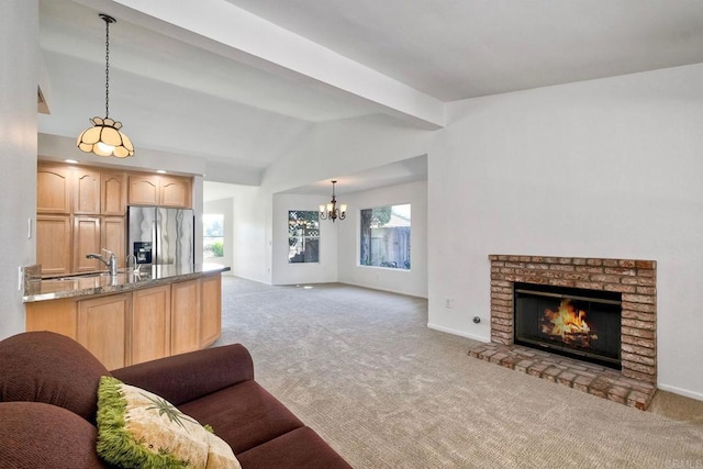 5261 Hubbert St, Oceanside, CA 92056 - kitchen featuring stainless steel fridge with ice dispenser, open floor plan, light colored carpet, and a chandelier