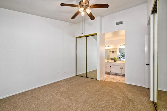 5261 Hubbert St, Oceanside, CA 92056 - unfurnished bedroom with light colored carpet, ensuite bath, a towering ceiling, and ceiling fan