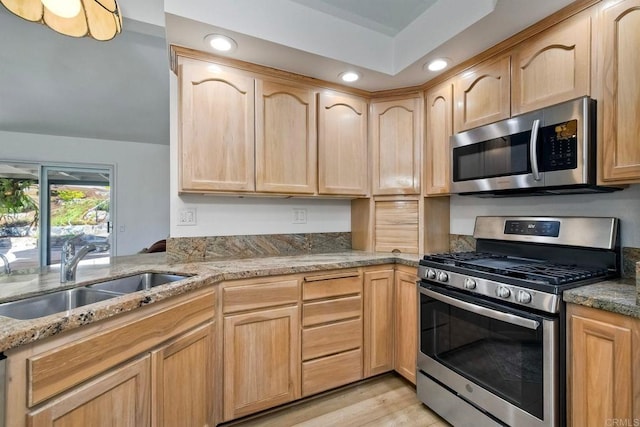 5261 Hubbert St, Oceanside, CA 92056 - kitchen featuring appliances with stainless steel finishes, light brown cabinets, light stone counters, recessed lighting, and light wood-type flooring