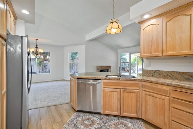 5261 Hubbert St, Oceanside, CA 92056 - kitchen with appliances with stainless steel finishes, open floor plan, a chandelier, light brown cabinetry, and a brick fireplace