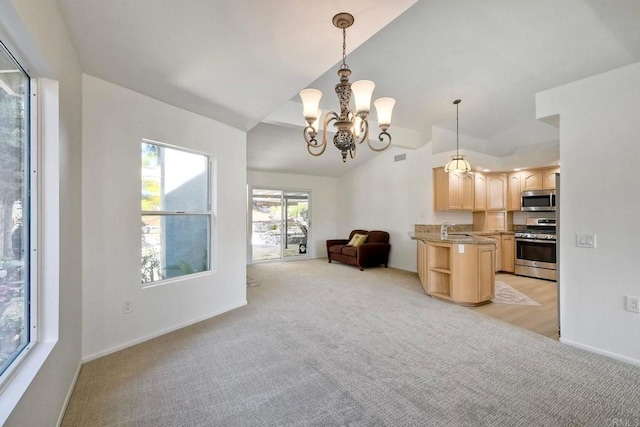 5261 Hubbert St, Oceanside, CA 92056 - kitchen with appliances with stainless steel finishes, light brown cabinetry, open floor plan, vaulted ceiling, and light carpet