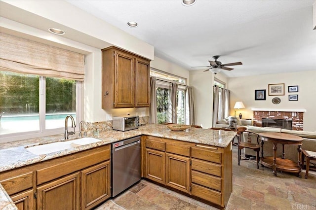 4635 Allende Ave, Oceanside, CA 92057 - kitchen featuring stainless steel dishwasher, a peninsula, light stone finish flooring, plenty of natural light, and recessed lighting