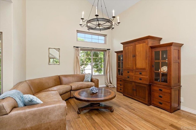 4635 Allende Ave, Oceanside, CA 92057 - living room with a chandelier, a towering ceiling, and light wood-style floors